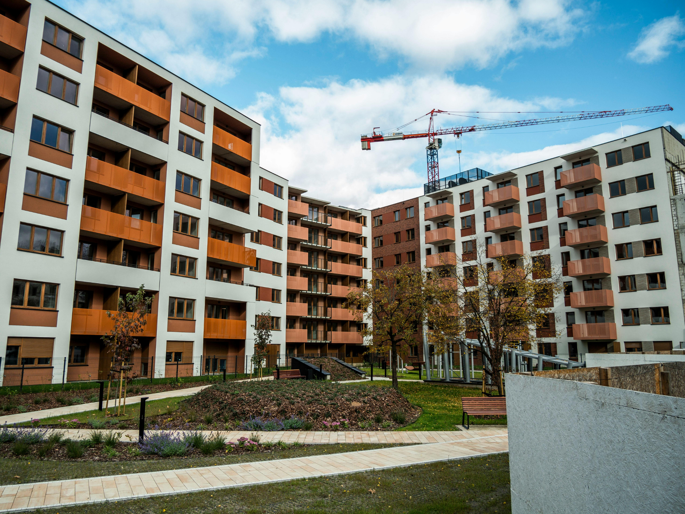 Prefabricated wall panels and modular construction assembly on a residential construction site.